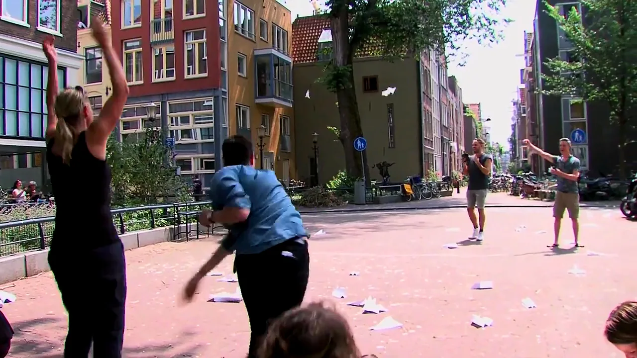 A Street Game team clambering over a statue by the Danube